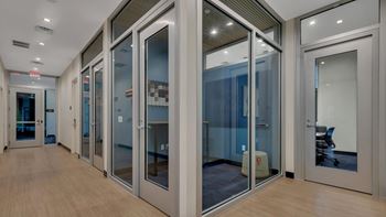Office corridor with glass walled conference rooms